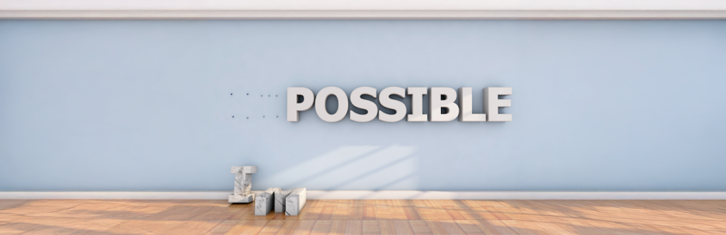 The word impossible on the wall with the letters I and M dropped on the floor so it instead reads possible.