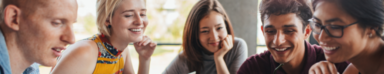 Diverse group of high school students engaged in looking at the same content